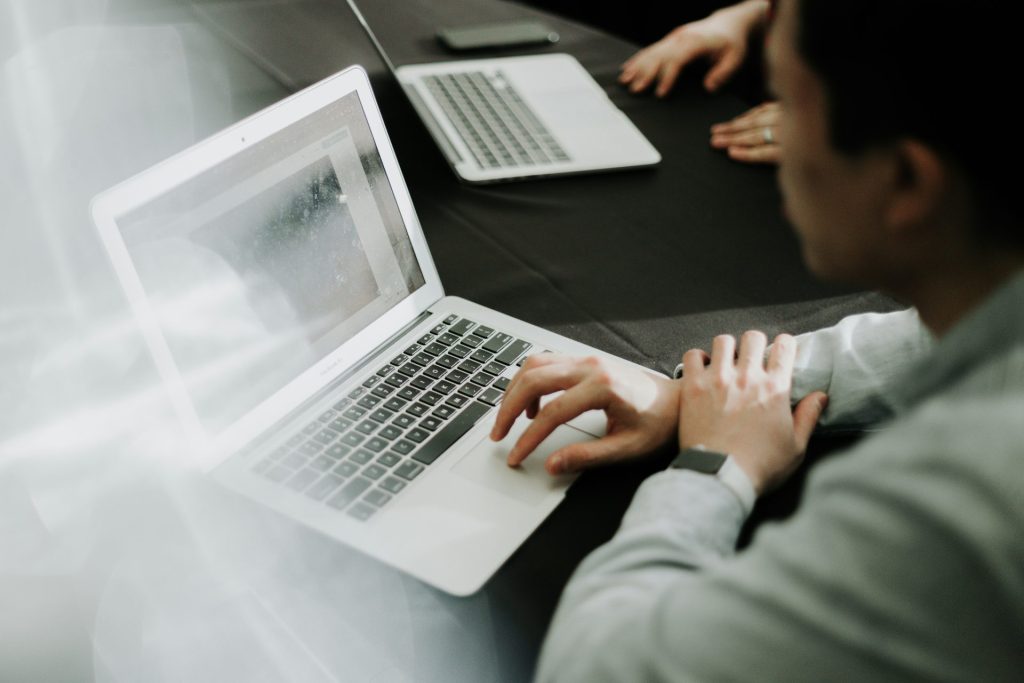 Person working on a laptop at desk.