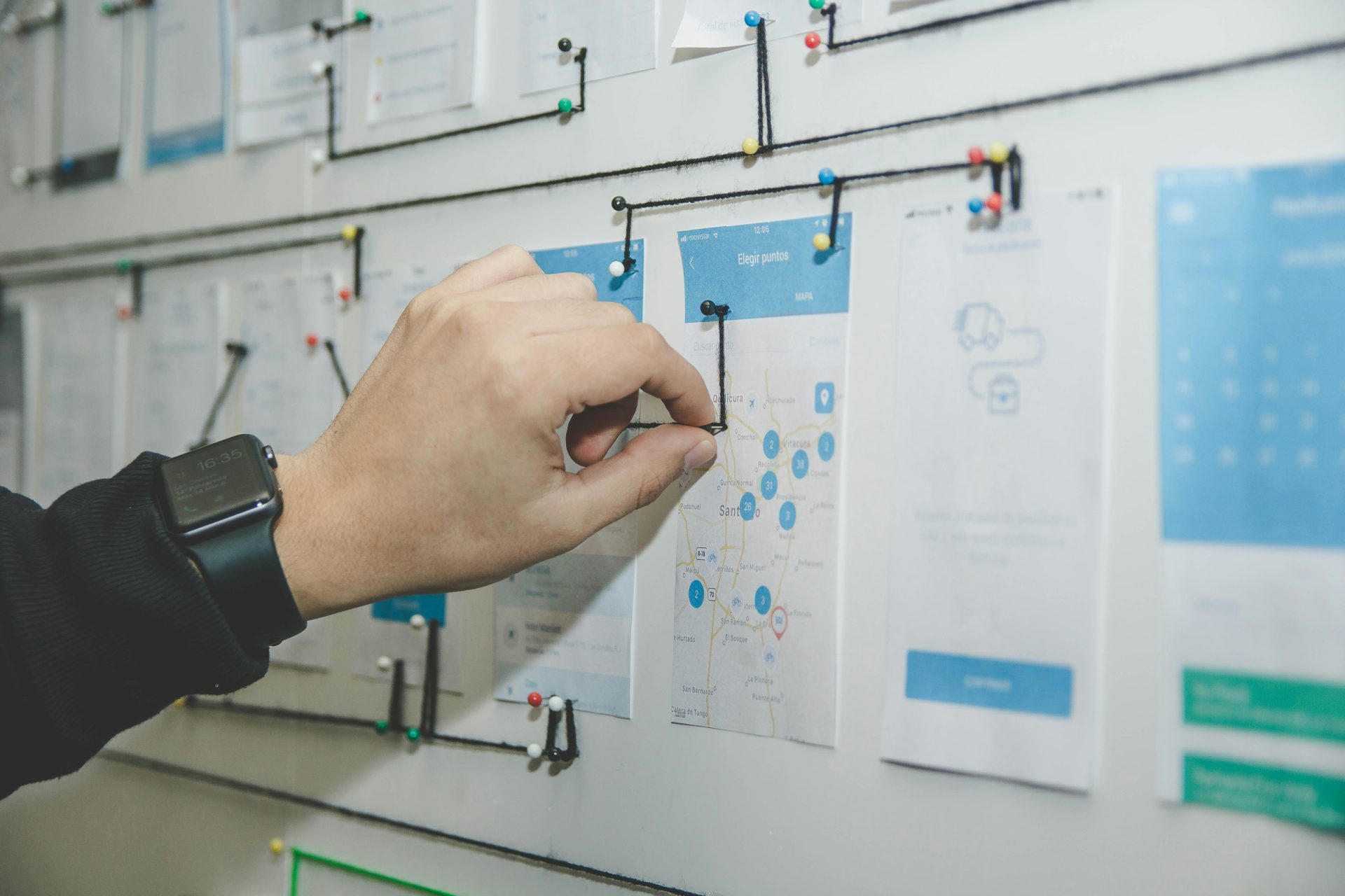 Hand pinning notes on a project board